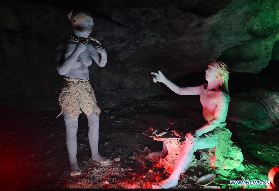 Photo shows the sculptures imitating ancient people's life at the Xianren Cave in Dayuan Township of Wannian County, east China's Jiangxi Province. Xianren Cave is the location for historically important finds of prehistoric pottery sherds and rice remains. (Xinhua/Zhou Ke)