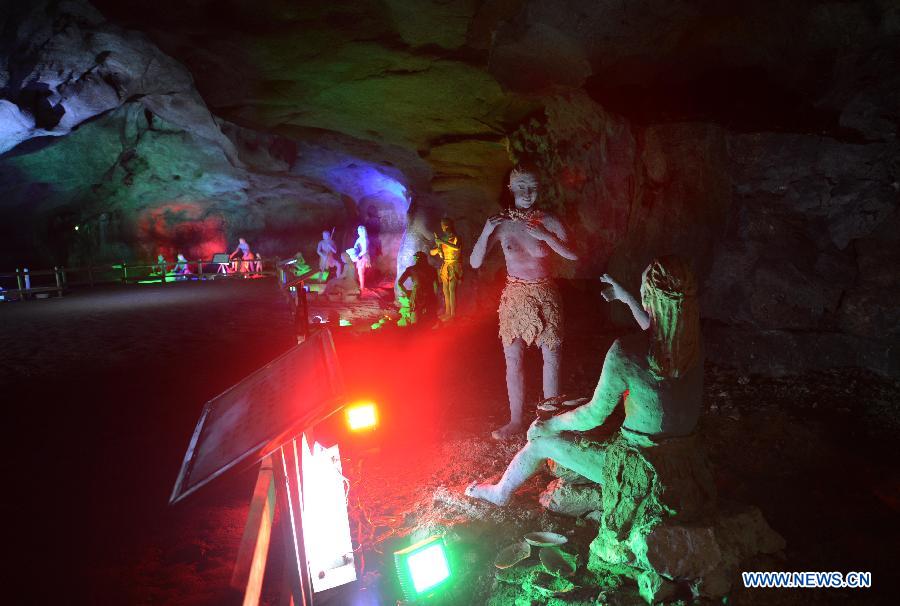 Photo shows the sculptures imitating ancient people's life at the Xianren Cave in Dayuan Township of Wannian County, east China's Jiangxi Province. Xianren Cave is the location for historically important finds of prehistoric pottery sherds and rice remains. (Xinhua/Zhou Ke)