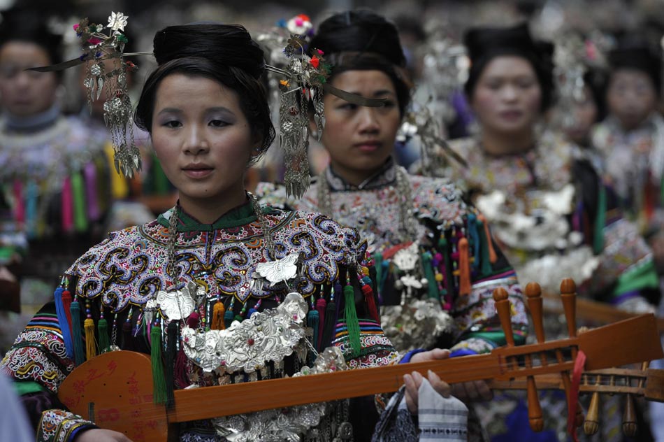 People of the Dong ethnic group take part in the Sama Festival on a street in Rongjiang County, southwest China's Guizhou Province, Dec. 18, 2012. (Xinhua/Ou Dongqu)