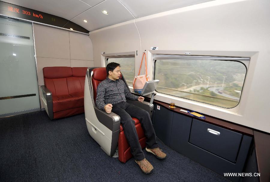 A passenger looks at the scenery out of the window in a tourist carriage of G80 express train during a trip to Beijing, capital of China, Dec. 22, 2012. (Xinhua/Chen Yehua) 