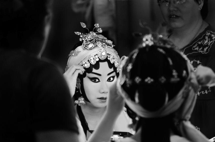 A Peking Opera actress is doing her make up. The photo "Mirror mirror" by Jessica Dowse from Britain received a second prize. (China.org.cnJessica Dowse)