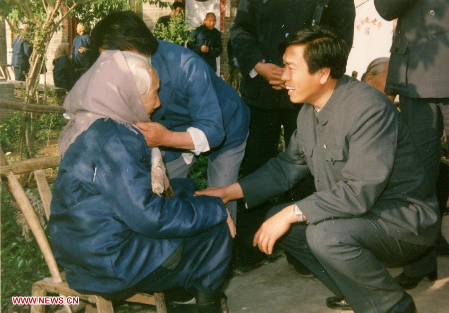 File photo shows Zhang Dejiang (R), then working in the Ministry of Civil Affairs, visits a centenarian woman during his investigation in rural nursing homes in central China's Henan Province. (Xinhua) 