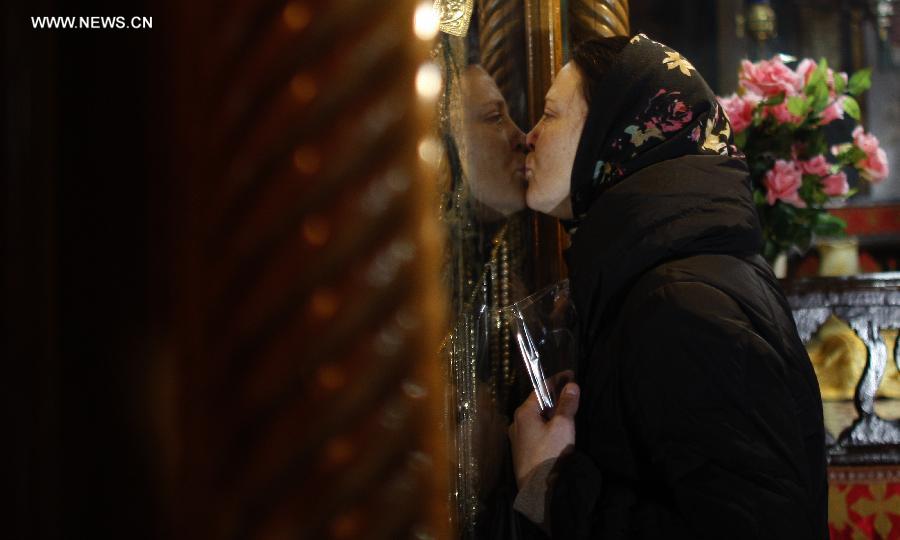 A worshiper prays inside the Grotto in the Church of the Nativity, traditionally believed to be the birthplace of Jesus Christ, as preparations for Christmas celebrations in the West Bank biblical town of Bethlehem on Dec. 24, 2012. (Xinhua/Fadi Arouri)