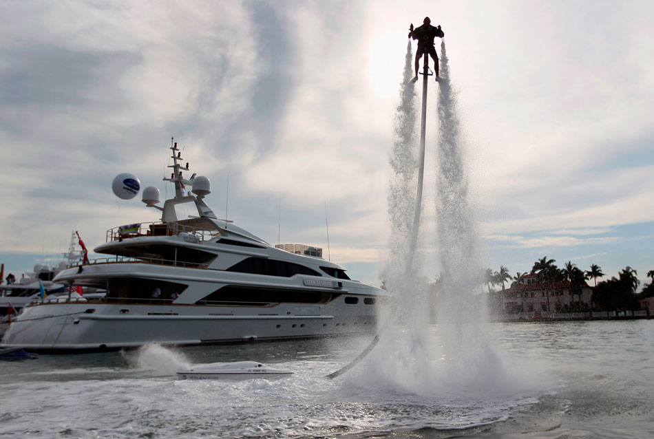 A man with the jet pack flies in the air above the Florida beach, United States, Feb. 17. Linking the jet pack with the engine block, the 10-meter-long soft pipe makes it possible for the jet pack to be used to entertain users, extinguish flames, paint bridges and rescue people. (Xinhua/AP)  