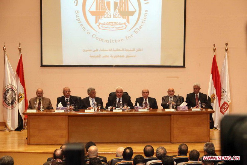 Head of Egyptian Supreme Elections Commission, Samir Ahmed Aboul-Maaty (C), speaks at a press conference in Cairo, Egypt, Dec. 25, 2012. Samir Ahmed Aboul-Maaty announced Tuesday evening that the newly-written draft constitution was approved by 63.8 percent of votes in referendum. (Photo/Xinhua) 