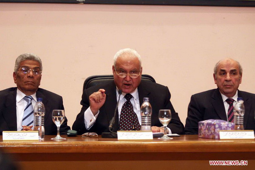 Head of Egyptian Supreme Elections Commission, Samir Ahmed Aboul-Maaty (C), speaks at a press conference in Cairo, Egypt, Dec. 25, 2012. Samir Ahmed Aboul-Maaty announced Tuesday evening that the newly-written draft constitution was approved by 63.8 percent of votes in referendum. (Photo/Xinhua) 