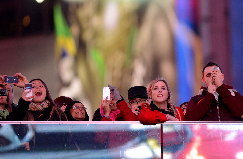 Tourists stay and enjoy the view on the Times Square in New York to embrace a new day in calm on Dec. 20, 2012. NASA has refuted the “Doomsday” rumor of Dec. 21, 2012 and made it become an entertainment to the world. (Xinhua/Wang Lei) 