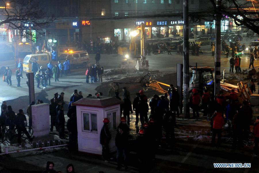 Workers fix the collapsed section of a road intersection in Taiyuan, capital of north China' Shanxi Province, Dec. 26, 2012. The road cave-in happened Wednesday afternnon, leaving a pit measuring around 3 to 4 meters deep, 15 meters long, and 5 meters wide. No casualties were reported. (Xinhua/Fan Minda)