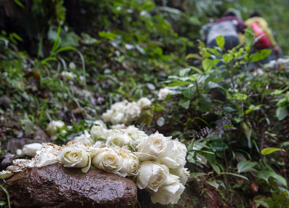 Flowers are left on the “Ladder of Love", which was built as a labor of love by Liu Guojiang and Xu Chaoqing. Five decades ago, 16-year-old Liu met 26-year-old Xu Chaoqing and fell in love with her, which was seen as a taboo for a young man to tie the knot with an older widow. They ran away and live a reclusive life in the mountains. Liu hand carved 6,000 stone steps as Xu’s safe access to the outside world. (Xinhua/Chen Cheng)