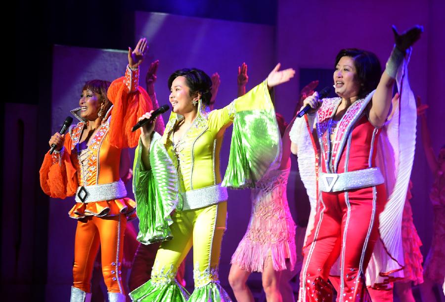 Actors and actresses perform in musical "Mamma Mia!" at the Gansu Grand Theater in Lanzhou, capital of northwest China's Gansu Province, Dec. 26, 2012. The Chinese version of classic musical "Mamma Mia!" was staged in Gansu with six performances starting from Dec. 25. Over 42 million people across the world have seen the musical since the original London production opened in 1999. (Xinhua/Zhang Meng) 