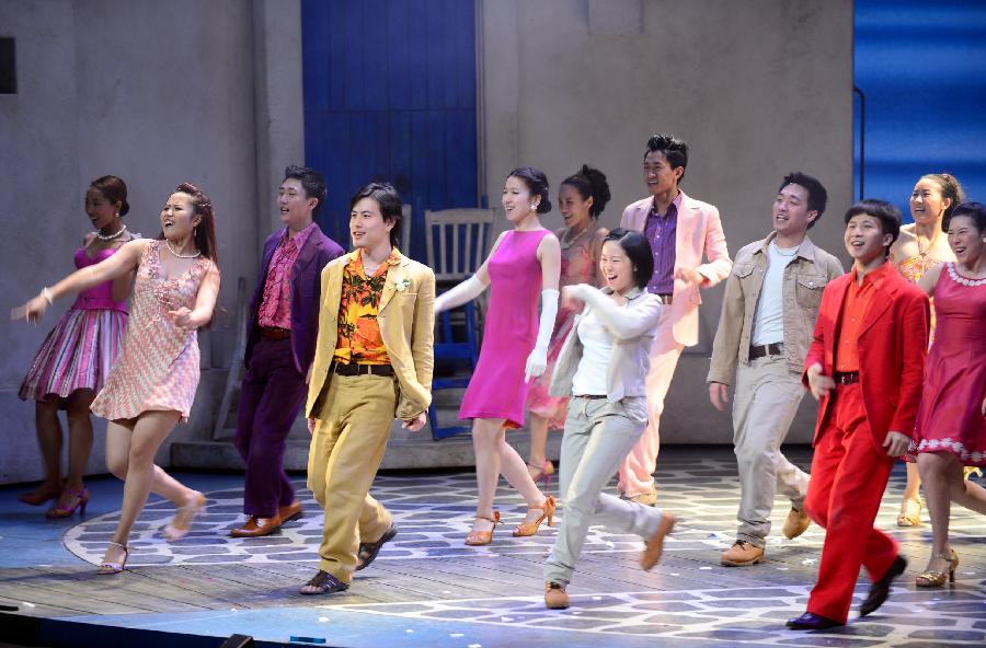 Actors and actresses perform in musical "Mamma Mia!" at the Gansu Grand Theater in Lanzhou, capital of northwest China's Gansu Province, Dec. 26, 2012. The Chinese version of classic musical "Mamma Mia!" was staged in Gansu with six performances starting from Dec. 25. Over 42 million people across the world have seen the musical since the original London production opened in 1999. (Xinhua/Zhang Meng) 