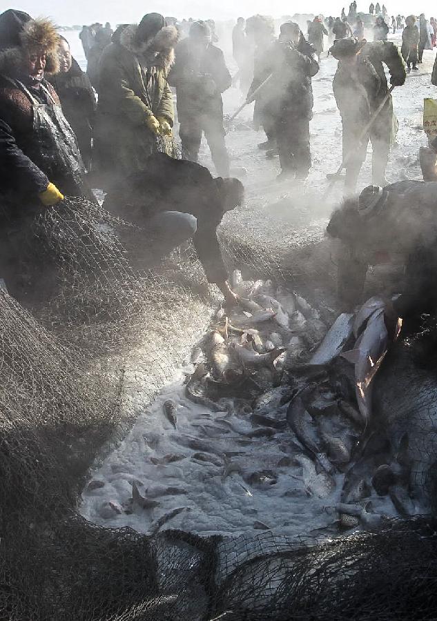 Local fishermen net fish during an ice fishing event in the Chagan Lake in Qian Gorlos Mongolian Autonomous County, northeast China's Jilin Province, Dec. 27, 2012. (Xinhua/Wang Haofei) 