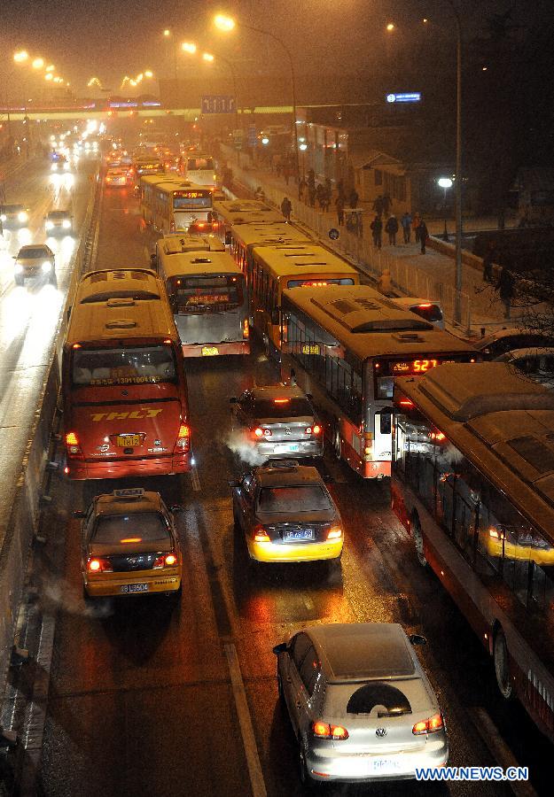 Vehicles pass on the West Changan Street in snow in Beijing, capital of China, Dec. 28, 2012. Beijing has witnessed the 7th snowfall in this winter on Friday. (Xinhua/He Junchang)