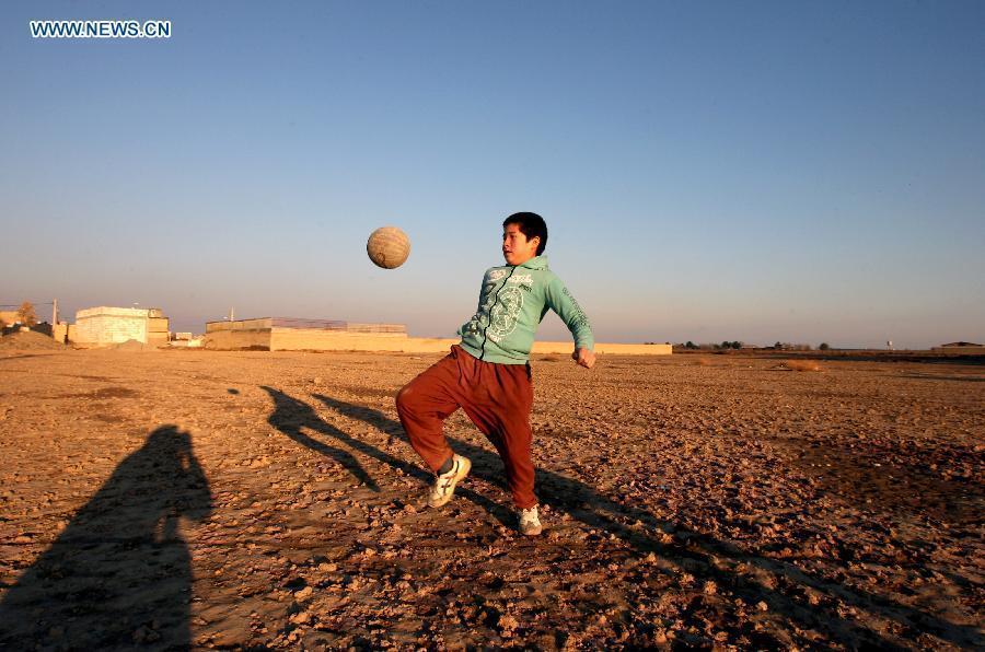 An Afghan refugee boy plays with a ball at a village near Tehran, capital of Iran, on Dec. 28, 2012. The United Nations High Commissioner for Refugees (UNHCR) statistics show that some 2.7 million Afghan refugees are still living outside their homeland due to more than three decades of conflicts and continuing insurgency in Afghanistan, with around 1.7 million in Pakistan and more than one million in Iran, waiting for a favorable environment to return home and reintegrate to their communities. (Xinhua/Ahmad Halabisaz) 
