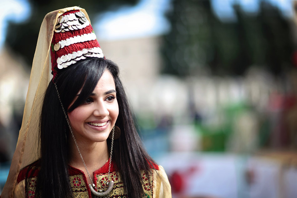 A girl wearing traditional costume attends the Christmas celebration activity in the Christian Quarter in Bethlehem, Dec. 24, 2012. Bethlehem is where Jesus was born according to the Bible. Pilgrims and tourists from all over the world came together to celebrate the festival.(Photo/Xinhua)