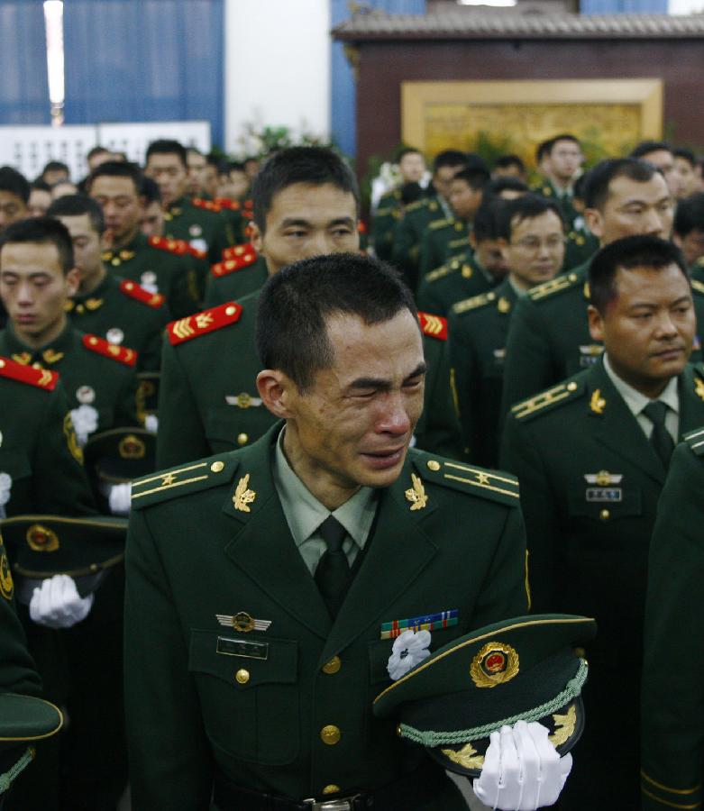 Firefighters mourn for their deceased colleagues who lost lives in a rescue operation on Jan. 1 at the Hangzhou Yusei Machinery Co., Ltd in Hangzhou, during a ceremony in Hangzhou, capital of east China's Jiangsu Province, Jan. 4, 2013. (Xinhua/Cui Xinyu) 