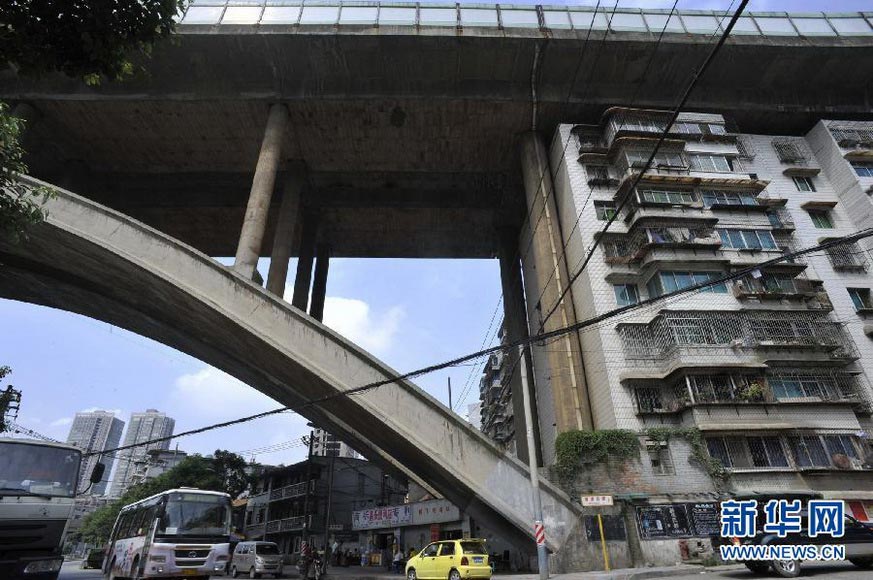 Humble dwelling under the bridge :There are more than 10 residential buildings under the 300-meter-long Shuikou Bridge, with the minimum distance between the roof and the bottom of the bridge being less than 1 meter. These buildings look like the piers of the bridge. Hundreds of households have been living under this bridge, which is the eastern exit of Guiyang city and the way to Longdongbao airport with heavy traffic. Every time when heavy vehicles pass by, the buildings with shake with the bridge. The residents already are already used to the small cracks on the walls and leakage in the ceiling. In 1990s, the land was acquired by the local government for the airport highway construction, and local residents were relocated to underneath bridge as compensation. (Xinhua/Ou Dongqu)