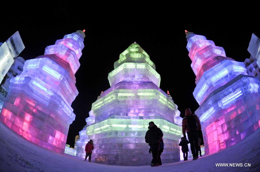 Visitors watch ice sculptures in the Ice and Snow World during the 29th Harbin International Ice and Snow Festival in Harbin, capital of northeast China's Heilongjiang Province, Jan. 5, 2013. The festival kicked off on Saturday. (Xinhua/Wang Song)