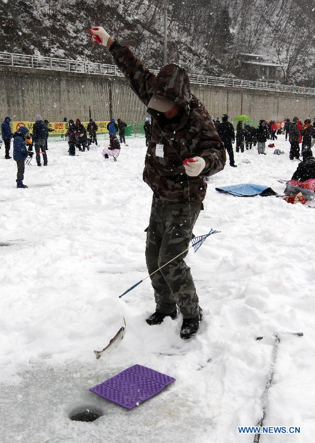 A man catches a fish on a frozen river during 2013 Hwacheon Sancheoneo Ice Festival in Hwacheon, South Korea, Jan. 5, 2013. The Sancheoneo Ice Festival lasts from Jan. 5 to 27. (Xinhua/Park Jin hee) 