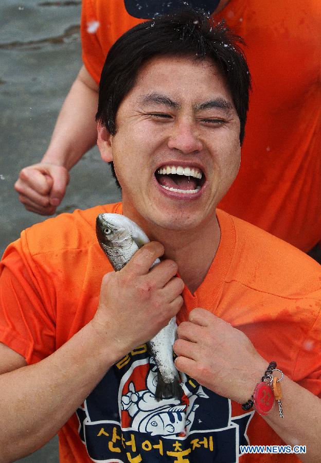 A man catches a fish in a river during 2013 Hwacheon Sancheoneo Ice Festival in Hwacheon, South Korea, Jan. 5, 2013. The Sancheoneo Ice Festival lasts from Jan. 5 to 27. (Xinhua/Park Jin hee)