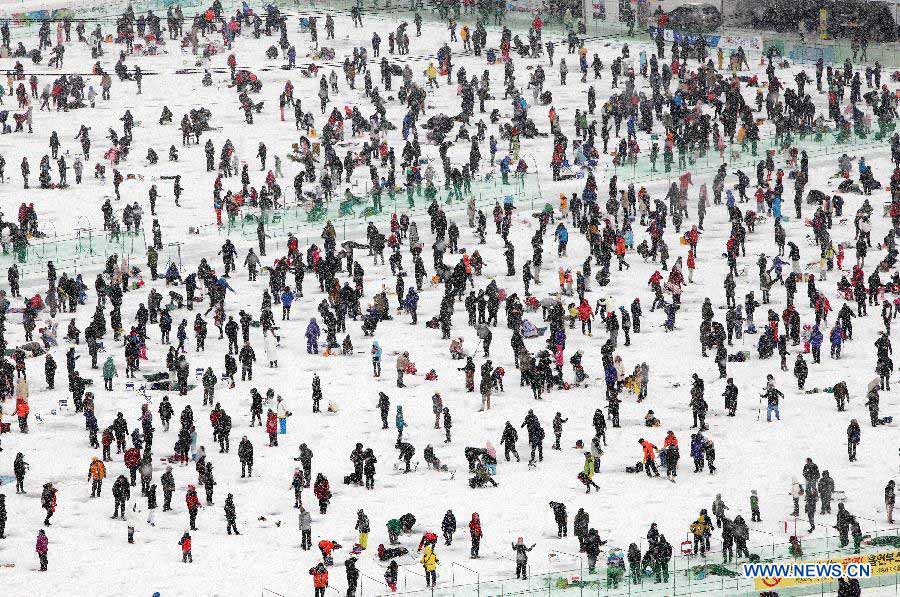 People fish on a frozen river during 2013 Hwacheon Sancheoneo Ice Festival in Hwacheon, South Korea, Jan. 5, 2013. The Sancheoneo Ice Festival lasts from Jan. 5 to 27. (Xinhua/Park Jin hee) 