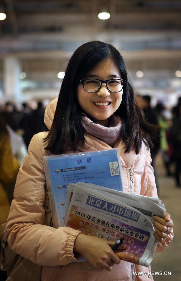 Zhang Yaoyue, a 24-year-old graduate from the University of Macau who is majored in English, is seen at a job fair for postgraduates in Beijing, capital of China, Jan. 6, 2013. Zhang wants to do translation or administrative work at a foreign company with a starting salary of 6,000 to 7,000 yuan (about 963 to 1,124 U.S. dollars) per month. (Xinhua/Wan Xiang)  