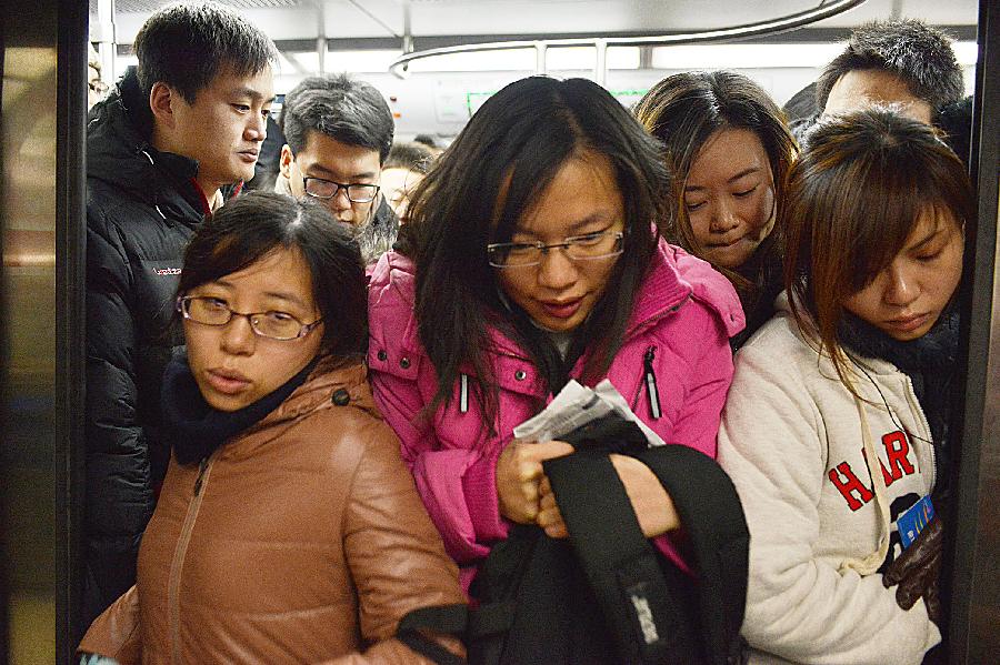 Commuters get off the train of subway line 10 at the Guomao Station, in Beijing, capital of China, Jan. 7, 2013. Subway line 10 has reached a daily transportation of 1 million passengers on average, just a week after Phase II's opening that completed a loop for former line 10. Subway line 10 is expected to become the busiest line in Beijing. (Xinhua/Wang Quanchao)