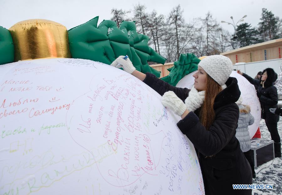 A girl writes her wishes for new year during a celebration on Orthodox Christmas at Sokolniky Park of Moscow, capital of Russia, on Jan. 7, 2013. Church services took place across Russia from Sunday to Monday to mark the Orthodox Christmas, with thousands of people attending ceremonies to celebrate the holiday. In accordance with the Julian calendar which was introduced by Julius Caesar in 45 B.C., the Orthodox Christmas takes place on Jan. 7, 13 days after the Western Christmas. (Xinhua/Jiang Kehong) 