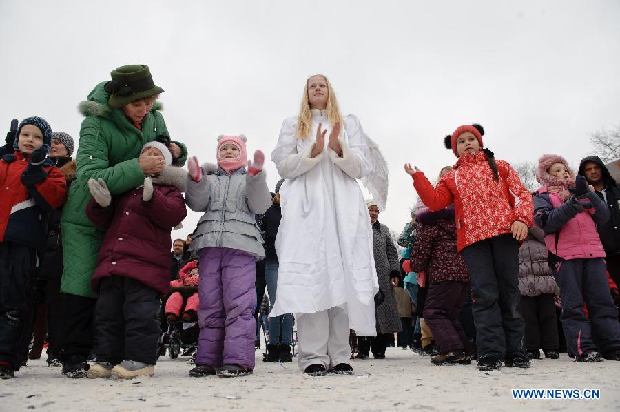 A girl dressed as angel dances with children during a celebration on Orthodox Christmas at Sokolniky Park of Moscow, capital of Russia, on Jan. 7, 2013. Church services took place across Russia from Sunday to Monday to mark the Orthodox Christmas, with thousands of people attending ceremonies to celebrate the holiday. In accordance with the Julian calendar which was introduced by Julius Caesar in 45 B.C., the Orthodox Christmas takes place on Jan. 7, 13 days after the Western Christmas. (Xinhua/Jiang Kehong) 
