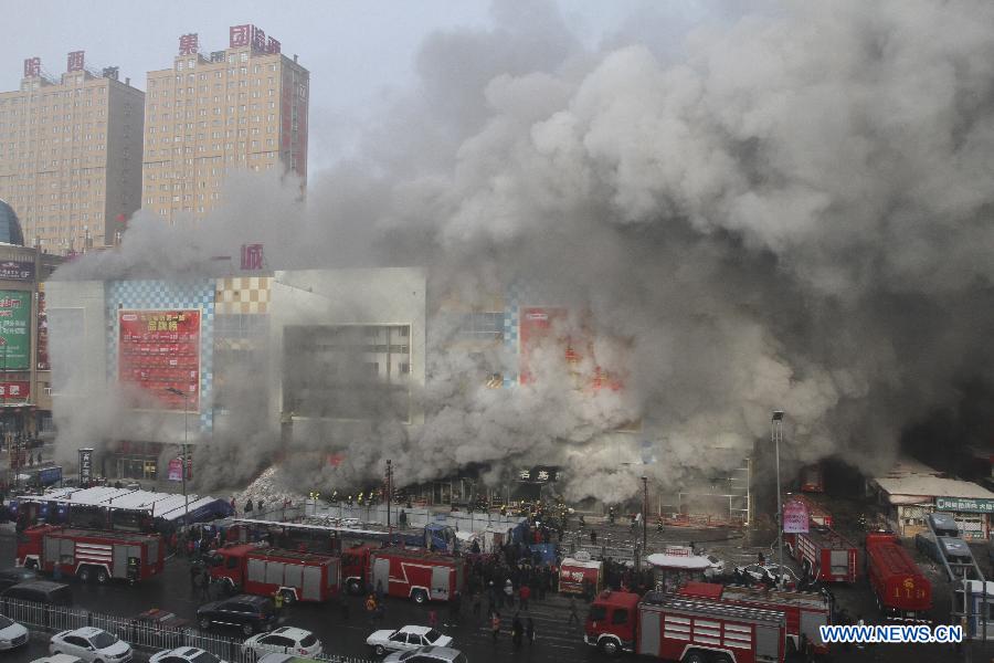 Firemen work to put out fire in a shopping mall in Harbin, capital of northeast China's Heilongjiang Province, Jan. 7, 2012. Casualty information is unknown yet after the fire started at around 9 a.m. (0100 GMT) in the Guorun Home Textiles Shopping Mall in downtown Harbin on Monday. The fire consumed an area of 9,400 square meters over the course of three and a half hours before being stopped. Firefighters helped evacuate shoppers from the five-story building. (Xinhua/Xiao Jinbiao) 