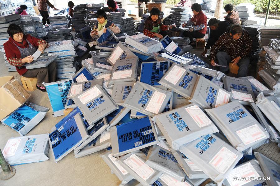 Photo taken on Nov. 11, 2012 shows staff members working at the warehouse of Hangzhou 7gege Company, an online store at Taobao.com in Hangzhou, capital of east China's Zhejiang Province. (Xinhua/Huang Zongzhi) 