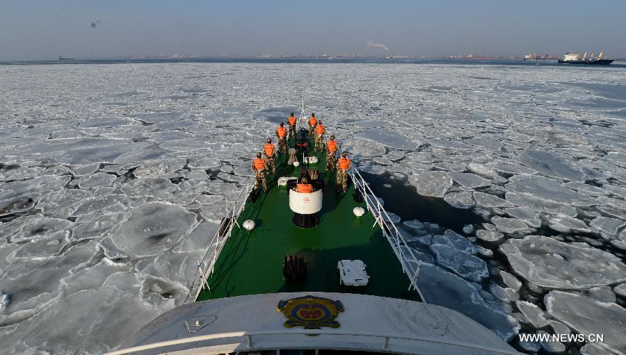 Local coastal police officers are on duty on the sea covered by drift ice, in Qinhuangdao, north China's Hebei Province, Jan. 8, 2013. A cold snap has created a layer of thick sea ice in the offshore areas of the Bohai Bay in Hebei Province. (Xinhua/Yang Shiyao)