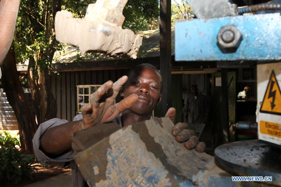 A worker processes clay materials at the Kazuri factory in Nairobi, Kenya, Jan. 8, 2013. Kazuri, which means "small and beautiful" in Swahili, began in 1975 as a workshop experimenting on making handmade beads. The factory employs over 340 women, mostly single mothers. Its handmade and hand-painted ceramic jewellery and pottery products have been exported to over 30 countries and regions worldwide. (Xinhua/Meng Chenguang)