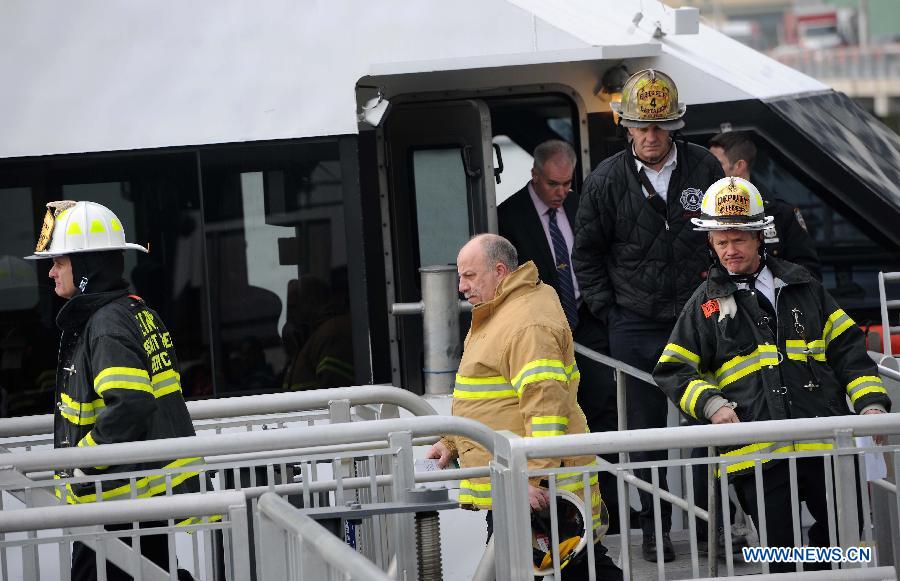 Firefighters work on a ferry boat which crashed into Pier 11 in lower Manhattan, New York, the United States, on Jan. 9, 2013. A high-speed ferry loaded with hundreds of commuters from New Jersey crashed into a dock near Wall Street on Wednesday during the morning rush hour, injuring 57 people. (Xinhua/Shen Hong)