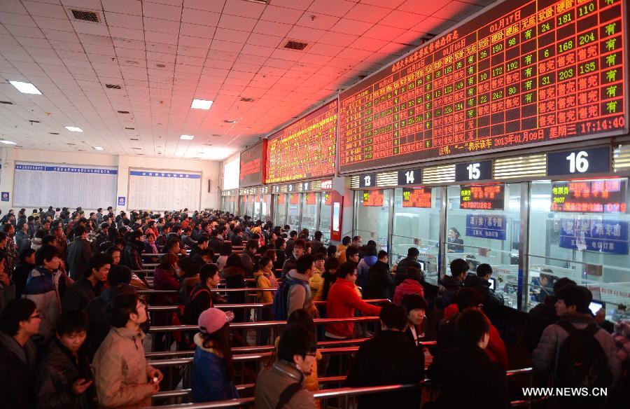 People line to buy railway tickets at Nanchang Railway Station in Nanchang, capital of east China's Jiangxi Province, Jan. 9, 2013. The tickets for the upcoming Spring Festival rush period can be purchased at ticket offices and agencies since Jan. 9. The 40-day 2013 Spring Festival travel rush will start on Jan. 26. The Spring Festival for family reunions begins from the first day of the first month of the traditional Chinese lunar calendar, or Feb. 10, 2013. (Xinhua/Zhou Ke) 