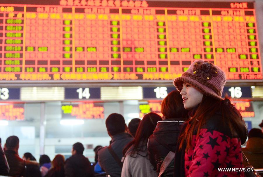 People line to buy railway tickets at Nanchang Railway Station in Nanchang, capital of east China's Jiangxi Province, Jan. 9, 2013. The tickets for the upcoming Spring Festival rush period can be purchased at ticket offices and agencies since Jan. 9. The 40-day 2013 Spring Festival travel rush will start on Jan. 26. The Spring Festival for family reunions begins from the first day of the first month of the traditional Chinese lunar calendar, or Feb. 10, 2013. (Xinhua/Zhou Ke) 