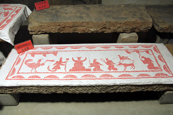 Shown is a piece of gravestone rubbing, or "tapian" in Chinese, created out of an ancient gravestone by cinnabar on Chinese rice paper in the Guanzhong Folk Art Museum in Xi'an, capital of China's northwestern Shaanxi province on Thursday, January 10, 2013. Gravestone rubbing is the practice of preserving the image of the surface of a stone on a paper by rubbing the stone over the paper. (CRIENGLISH.com/Liu Kun)  
