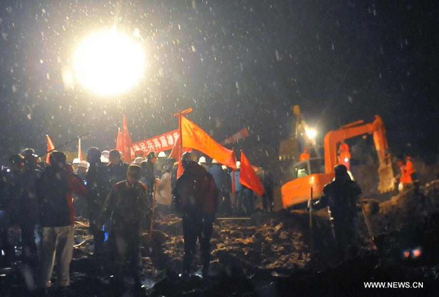 Rescuers work at the mud-inundated debris after a landslide hit Gaopo Village in Zhenxiong County, southwest China's Yunnan Province, Jan. 11, 2013. (Xinhua/Chen Haining)