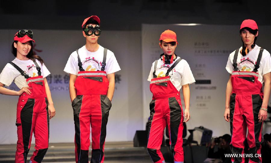 Models present outfits at a creative fashion design competition held at Tianjin Polytechnic University in north China's Tianjin, Jan. 11, 2013. The competition held its final here Friday. (Xinhua/Zuo Shan)