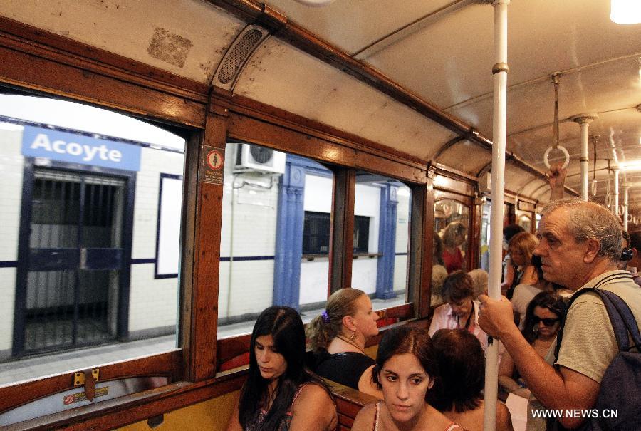 Passengers ride on a wagon of the A line subway in Buenos Aires, Argentina, on Jan. 11, 2013. The A line subway service would be closed since Jan. 12 and the Belgian original historic wooden cars, which have been in service for almost 100 years, would be repalced by upgraded Chinese-made wagons. (Xinhua/Alberto Raggio)