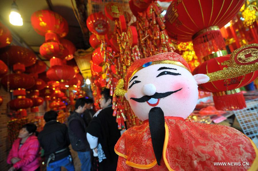 Citizens purchase ornaments to greet the upcoming Spring Festival, which falls on Feb. 10 this year, at a shop in Haikou, south China's Hainan Province, Jan. 12, 2013. (Xinhua/Guo Cheng) 