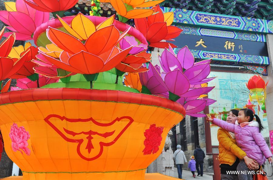 Visitors view lanterns displayed to greet the upcoming Spring Festival, which falls on Feb. 10 this year, in Zhoucun, east China's Shandong Province, Jan. 12, 2013. (Xinhua/Dong Naide) 