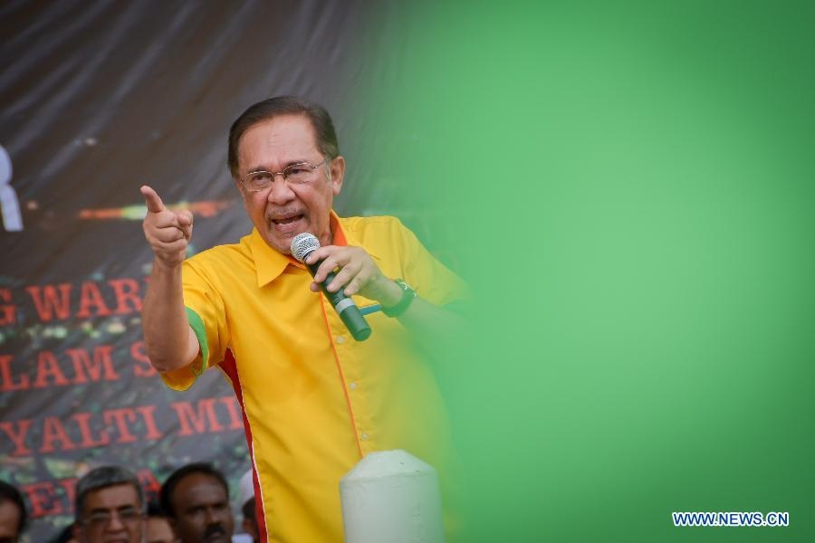 Opposition coalition People Alliance's leader, Anwar Ibrahim, addresses the crowd during the opposition People's Uprising Assembly in Kuala Lumpur, Malaysia, Jan. 12, 2013. Hundreds of thousands marched to Malaysia's historical Independence Stadium in downtown Kuala Lumpur on Saturday in a colorful, opposition-backed rally counting down to a general election due before mid-2013.(Xinhua/Chong Voon Chung)