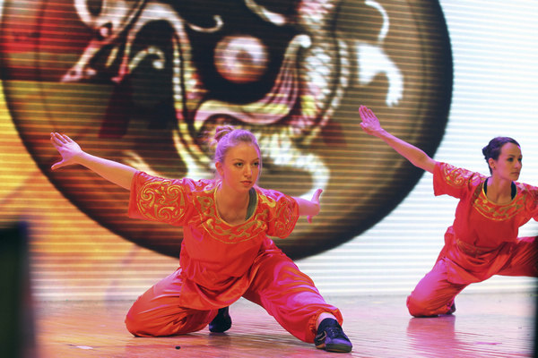 International students from the Capital University of Physical Education and Sports perform kung fu during the Ministry of Education's 2013 New Year reception for international graduates, held at the University of International Business and Economics in Beijing. (Photo by Zhu Xingxin / China Daily)