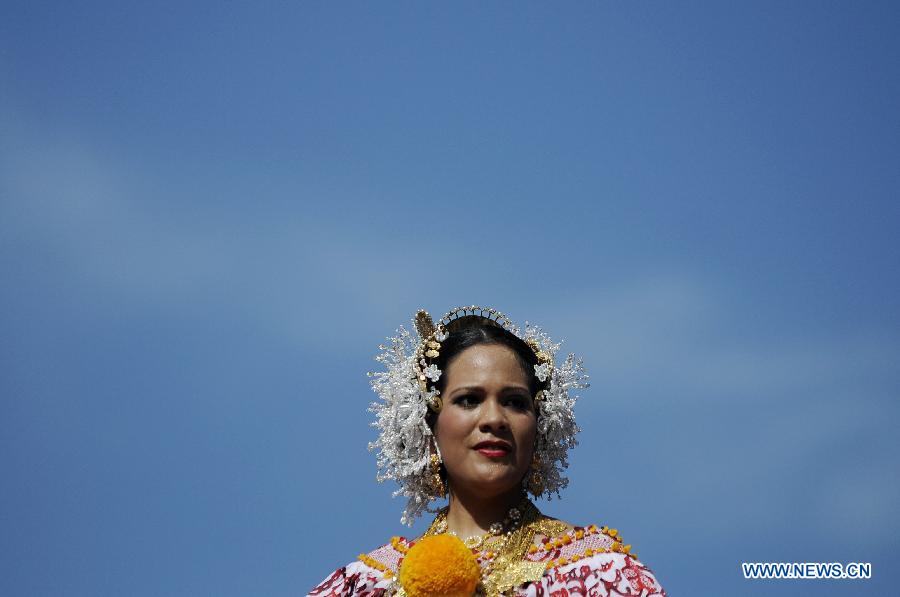 A woman wearing the traditional dress of Pollera participates in the Parade of 1,000 Polleras in Las Tablas, Panama, on Jan. 12, 2013. Polleras are traditional handmade costumes worn by Panamanian women mostly in folklore festivities. According to parade organizers, almost every part of the costume is made by hand and the assortment of head, neck and chest jewelry worn with a pollera can cost as much as 20,000 U.S. dollars. (Xinhua/Mauricio Valenzuela) 