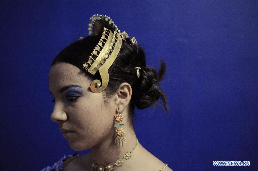 A woman wearing the traditional dress of Pollera waits to participate in the Parade of 1,000 Polleras in Las Tablas, Panama, on Jan. 12, 2013. Polleras are traditional handmade costumes worn by Panamanian women mostly in folklore festivities. According to parade organizers, almost every part of the costume is made by hand and the assortment of head, neck and chest jewelry worn with a pollera can cost as much as 20,000 U.S. dollars. (Xinhua/Mauricio Valenzuela) 