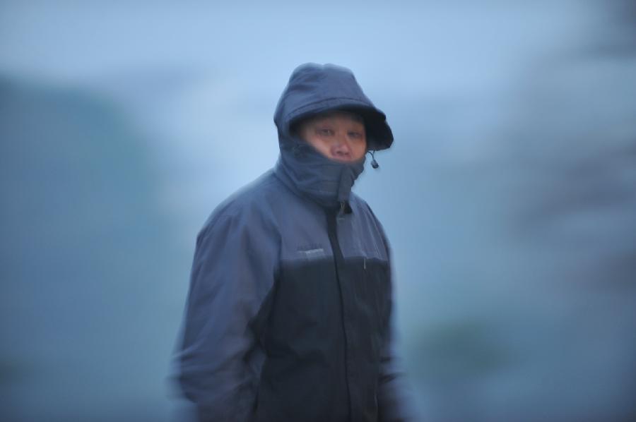 A man walks on a fog-shrouded street in Hefei, capital of east China's Anhui Province, Jan. 13, 2013. Dense fog on Sunday hit China's east and central regions from the northeast to the south. (Xinhua/Yang Xiaoyuan) 