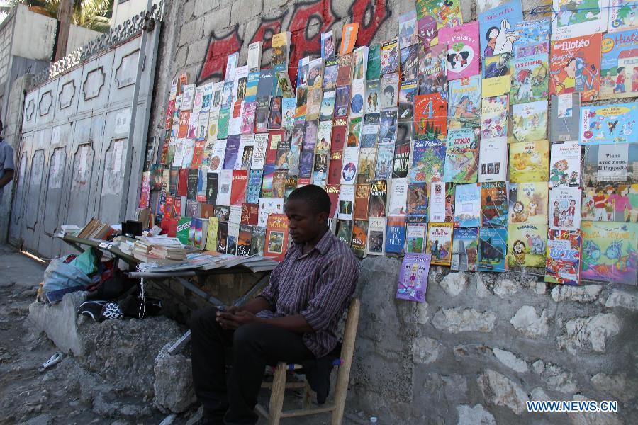A man sells books and publications on a street in the city of Port au Prince, capital of Haiti, on Jan. 12, 2013. Haitian President Michel Martelly called for patience from survivors on Saturday on the third anniversary of the 2010 earthquake that killed more than 200,000 people. (Xinhua/Zhu Qingxiang)