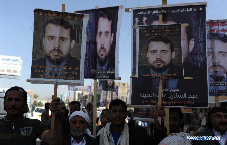 Family members of Yemeni prisoners in Guantanamo display the pictures of them during a rally demanding the release of prisoners held in Guantanamo, in front of the Yemeni President's Palace, in Sanaa, Yemen, Jan. 14, 2013. (Xinhua/Mohammed Mohammed)