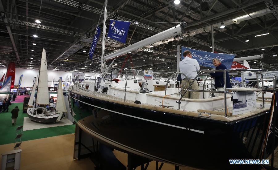 Visitors chat with a seller at the 58th London Boat Show, held at the ExCeL Exhibition and Convention Centre in London, Jan. 14, 2013. The 58th London Boat Show showcases, demonstrates and sells maritime equipments including luxury yachts, dinghies, boating equipment and clothing with interactive sections and features attractions devoted to boating until Jan. 20, 2013. (Xinhua/Wang Lili) 